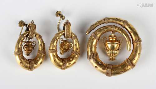 A Victorian gold brooch of coiled form with applied bead and...