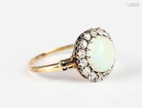 A gold, opal and diamond cluster ring, claw set with the ova...