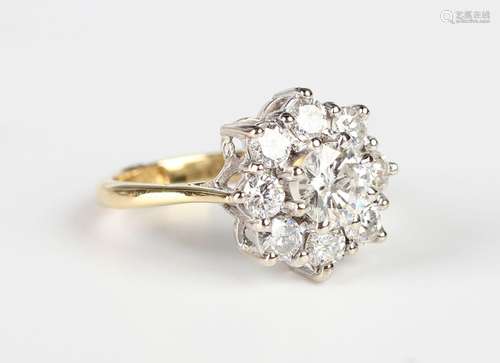 A gold and diamond cluster ring in a flowerhead shaped desig...