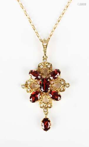 A 9ct gold, garnet and seed pearl pendant, pierced in a quat...