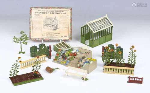 A Britains No. 053 span roof greenhouse, complete with stagi...