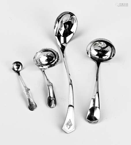 Four silver serving spoons