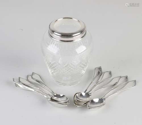 Spoon vase with silver spoons