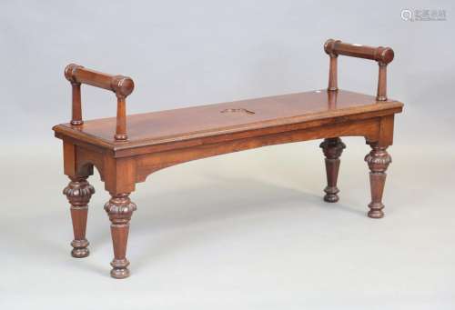 A mid-Victorian mahogany hall seat, the moulded seat with a ...