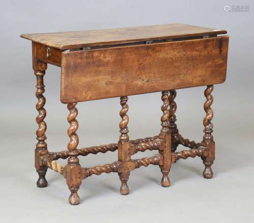 A Charles II walnut single drop-flap gateleg side table, fit...