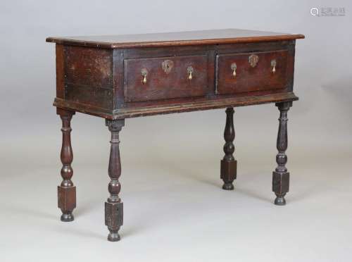 An early 18th century oak dresser base, fitted with two draw...