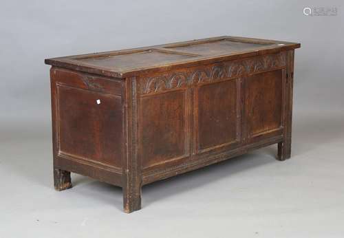 An early 18th century oak panelled coffer with wire hinges a...