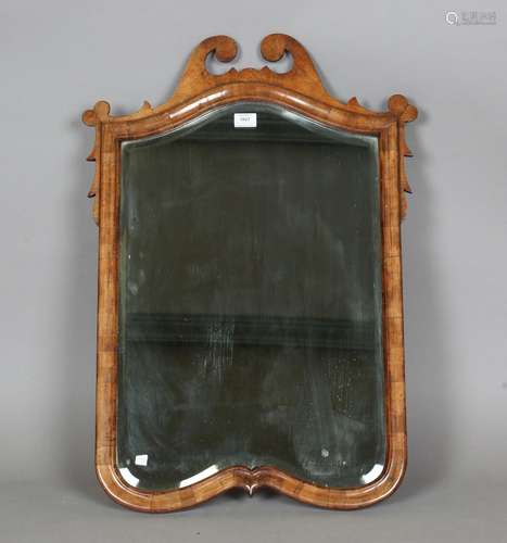 An early 20th century Queen Anne style walnut wall mirror wi...