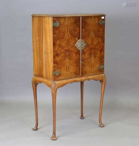 A mid-20th century Queen Anne style walnut drinks cabinet wi...