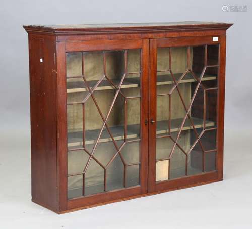 A George III mahogany glazed bookcase with boxwood stringing...