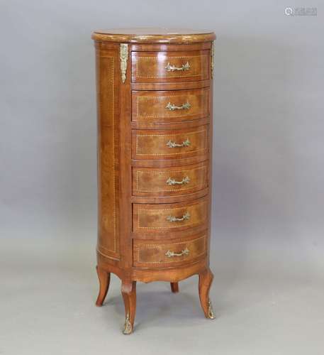 A late 20th century elm and walnut circular chest of six dra...