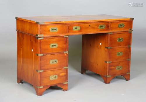 A 20th century reproduction yew campaign style twin pedestal...