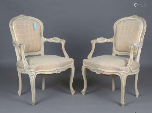 A pair of early 20th century French painted showframe fauteu...