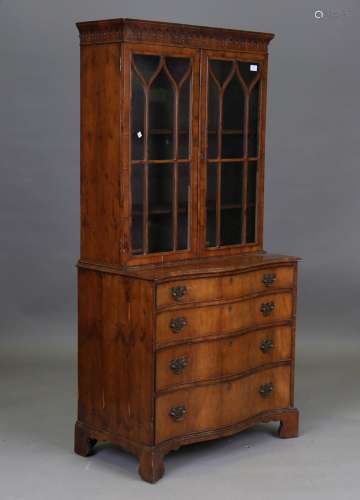 An early 20th century George III style yew bookcase cabinet,...