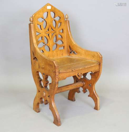 A late Victorian Gothic Revival oak hall chair, in the manne...