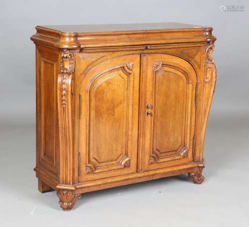 A late 19th century French walnut side cabinet, the concave ...