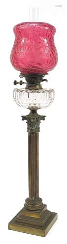 Victorian brass Corinthian column oil lamp with cranberry gl...