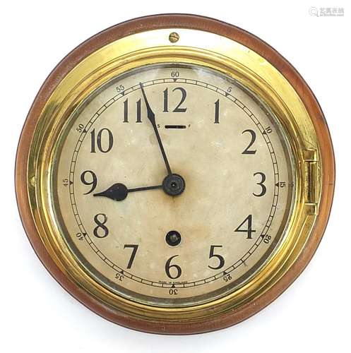 Brass ships bulkhead clock mounted on wooden back, 23cm in d...