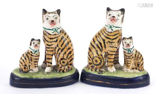 Pair of Staffordshire style pottery cat groups, each 18.5cm ...