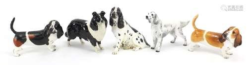 Four Coalport dogs and a Beswick Collie dog, the largest 18c...