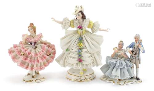 Two Dresden porcelain lace figurines and a group of two love...