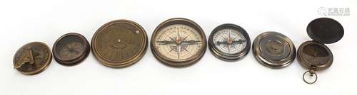 Four brass nautical interest compasses and sun dials, the la...