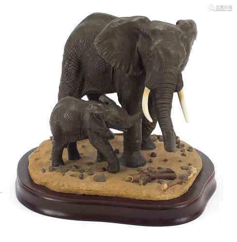 Elephant and calf group raised on a hardwood stand, 22cm hig...