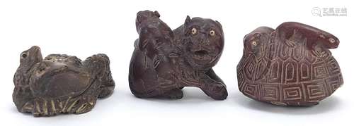 Three Japanese carved wood netsukes comprising tiger, toad a...