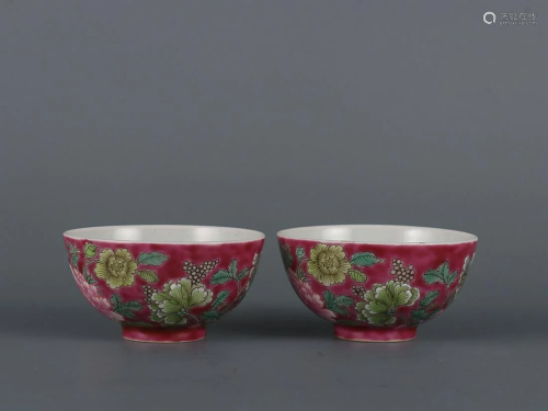 TWO CHINESE PUCE-GROUND FAMILLE-ROSE CUPS DEPICTING 'FL...