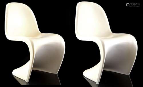 2 white plastic chairs