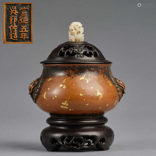 A gold-splashed bronze incense burner with wood stand and wo...