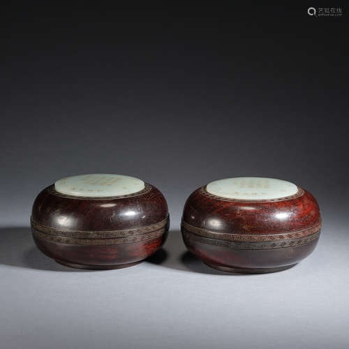 A pair of gilt-painted white jade inlaid red sandalwood boxe...