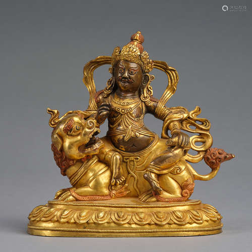 A gilt-copper alloy figure of 'Buddha ridding on a lion' ,Qi...