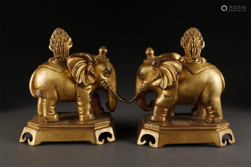 A PAIR OF TIBETAN GILT BRONZE ELEPHANT STATUES.