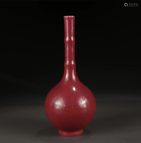 A CARMINE GLAZED LONG-NECK PORCELAIN BOTTLE.