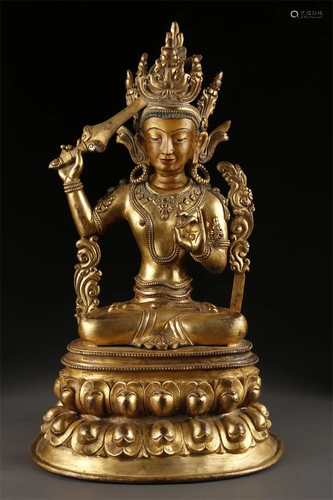 A TIBETAN GILT BRONZE ACALANATHA BUDDHA STATUE.