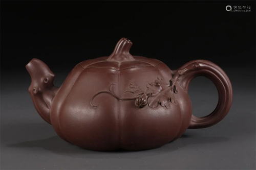 A RIDGED MELON-SHAPED PURPLE CLAY TEAPOT.