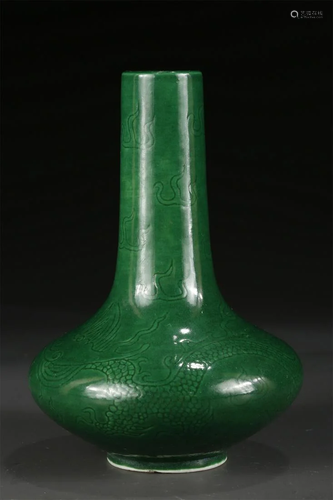 A GREEN GLAZED CHUFA-SHAPED PORCELAIN BOTTLE.