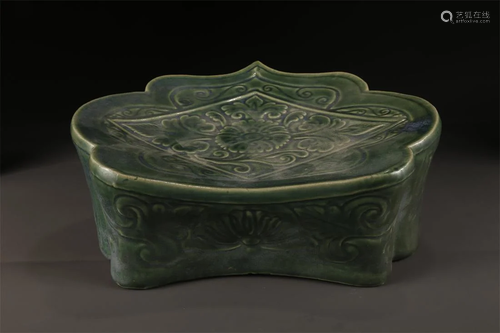 A GREEN GLAZED PORCELAIN PILLOW.