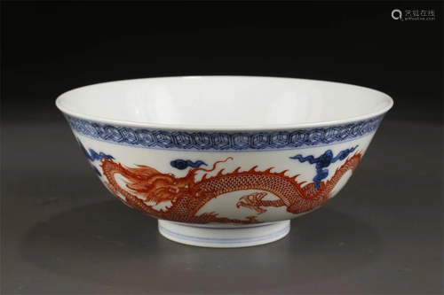 A BLUE-AND-WHITE BOWL WITH DRAGON DESIGN.