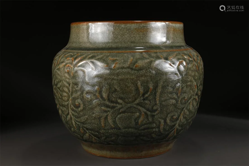 A DARK GREEN GLAZED PORCELAIN JAR.