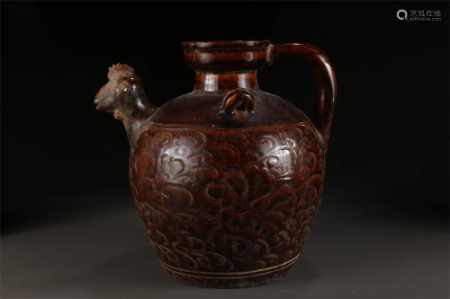 A BROWN GLAZED PORCELAIN POT WITH HANDLE.