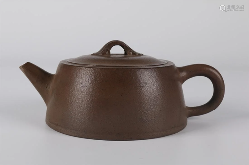 A PURPLE CLAY ROUND TEAPOT.