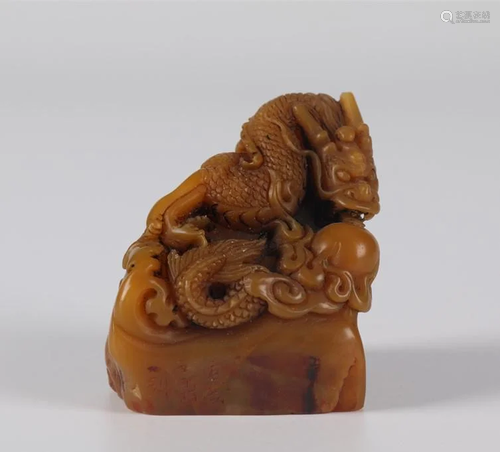 A FIELD-YELLOW STONE SEAL WITH DRAGON DESIGN.