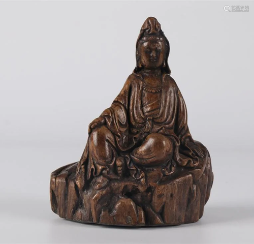 AN AGALWOOD SITTING AVALOKITESVARA STATUE.