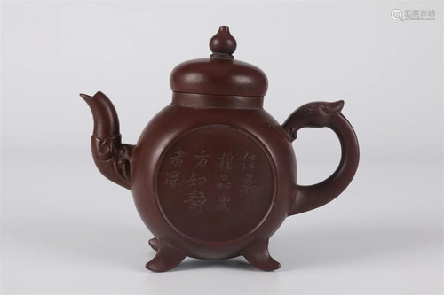 A PURPLE CLAY TEAPOT WITH DRAGON-SHAPED SPOUT.