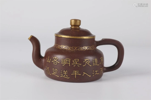 A PURPLE CLAY TEAPOT WITH GOLDEN POEM DESIGN.