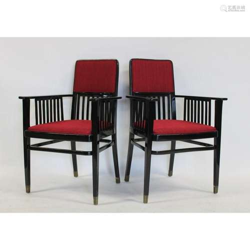 A Midcentury Pair Of Ebonised Arm Chairs.