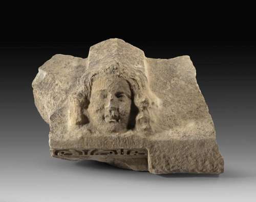 Marble relief fragment of a gabled sarcophagus lid.