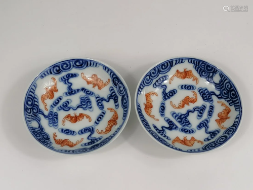 A Chinese blue white and iron red bats and clouds saucers